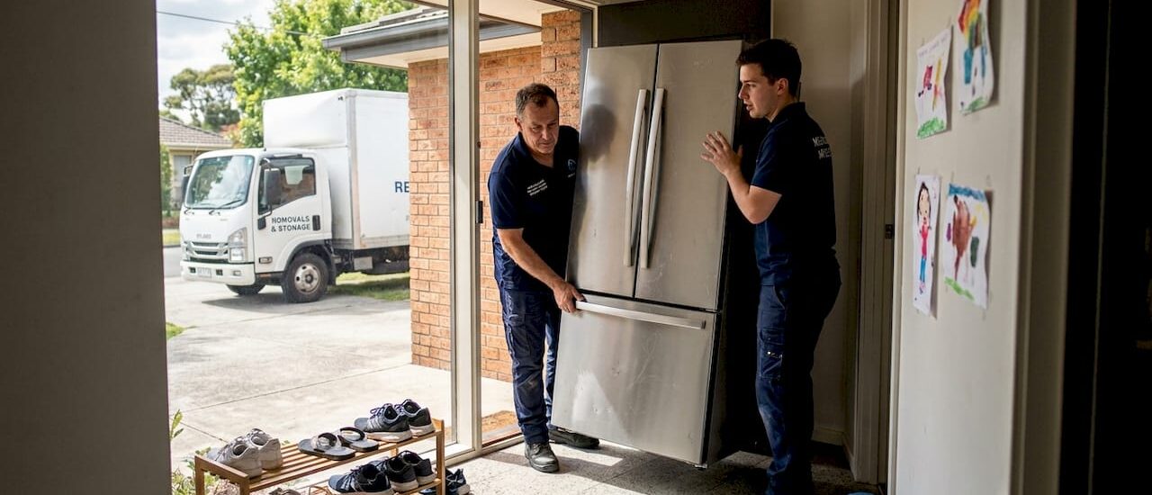 Removalists moving large fridge from Melbourne home
