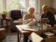 Older couple wrapping keepsakes during move