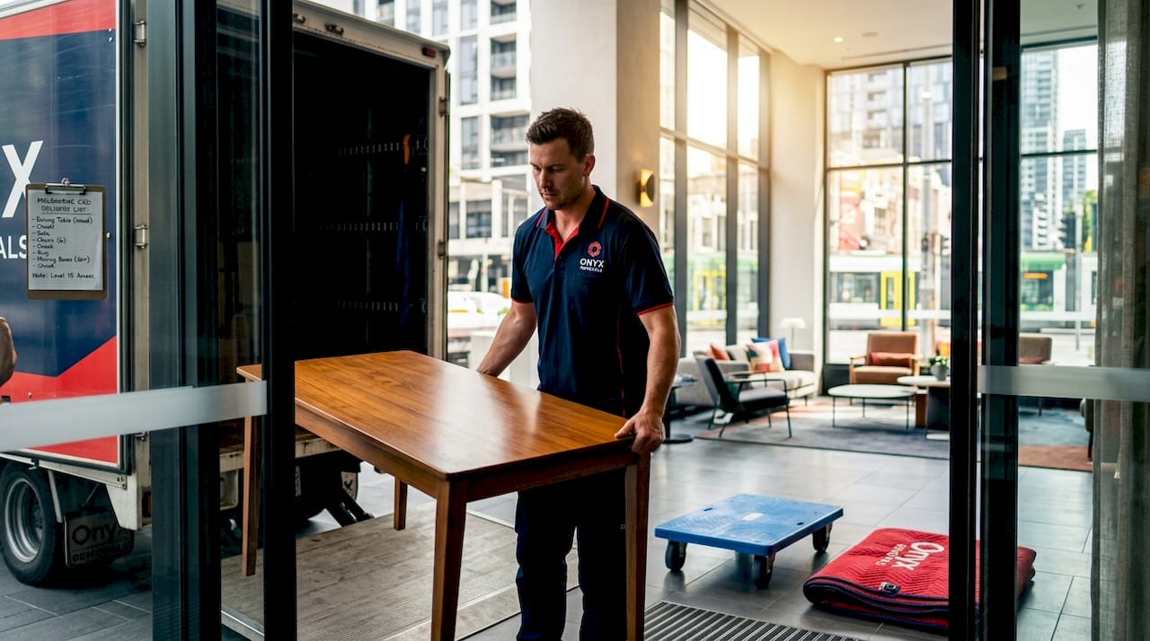 Removalist unloads furniture in Melbourne CBD lobby