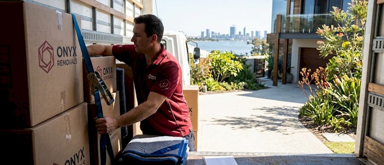 Removalist securing moving truck in Perth driveway
