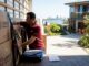 Removalist securing moving truck in Perth driveway