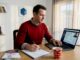 Man planning interstate move at home office desk