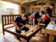 Movers dismantling bed frame in home