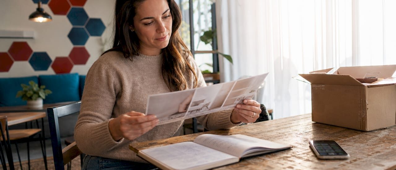 Person planning budget moving at home table