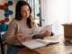 Person planning budget moving at home table