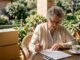 Senior woman reviewing relocation checklist at home