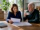 Senior move manager consulting elderly client at home