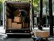 Man loading boxes into rental moving truck