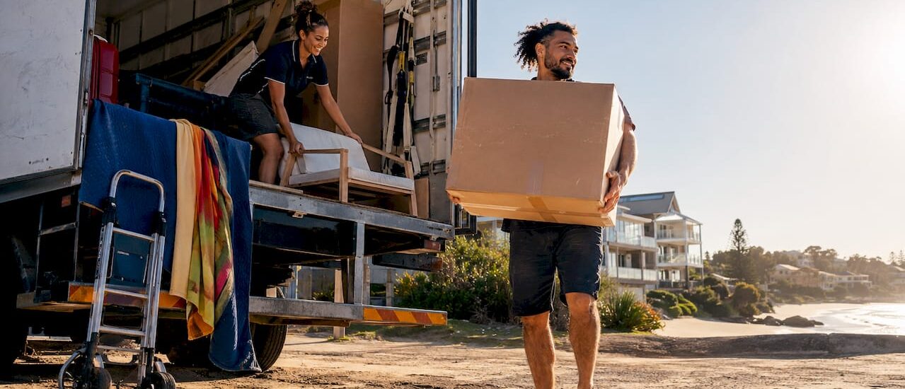 Two movers loading truck at suburban home Australian style