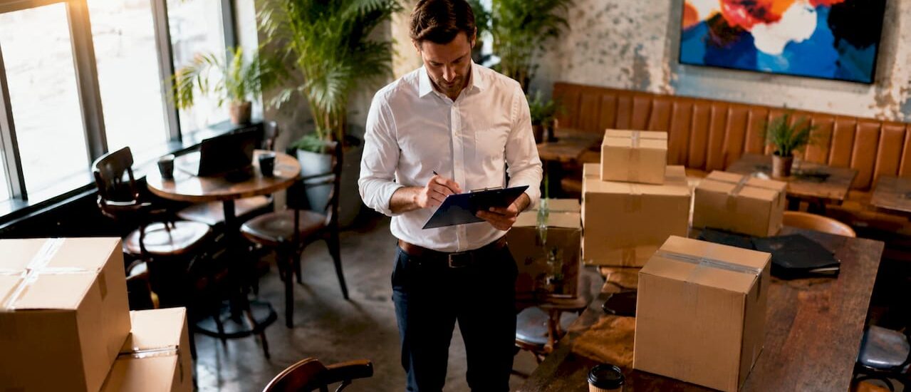 Manager checking moving schedule in office lobby