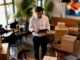 Manager checking moving schedule in office lobby