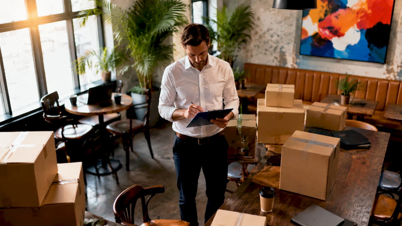 Manager checking moving schedule in office lobby