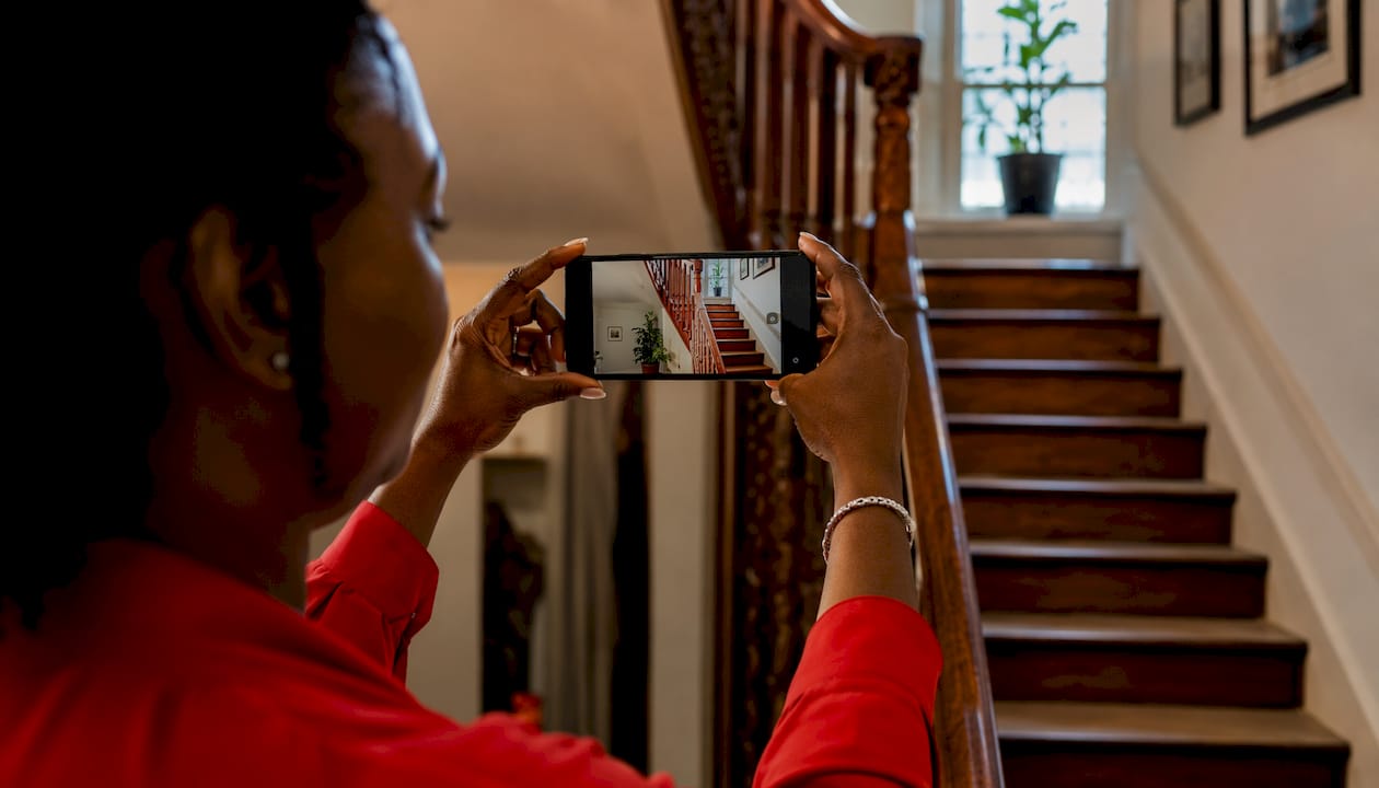 Hands filming stairwell for moving survey