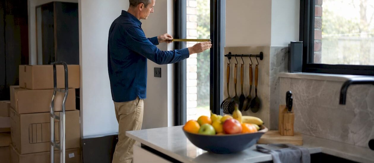 Man measuring doorway for moving access