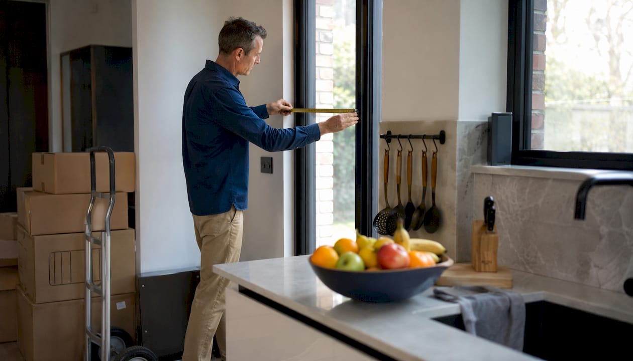 Man measuring doorway for moving access