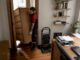 Mover carrying heavy dresser down stairs