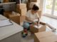 Renter packing labeled boxes for move-out