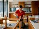 Furniture dismantler working on wooden table indoors