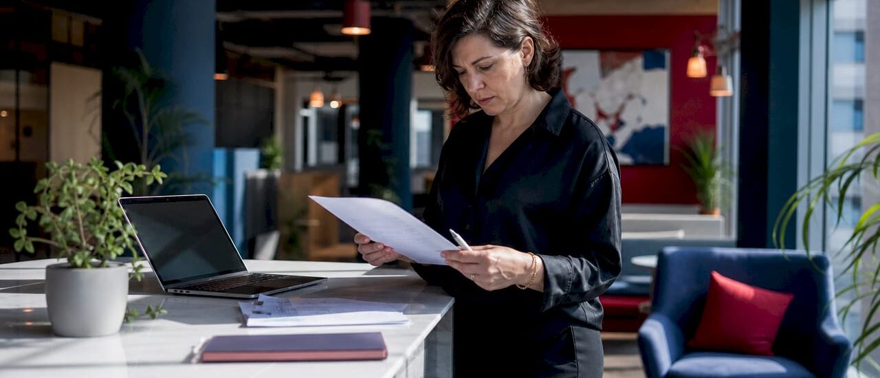 Office manager reviewing relocation brief paper