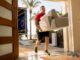 Furniture delivery worker bringing sofa inside home