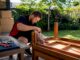 Removalist disassembling furniture in home