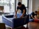 Movers wrapping couch in Melbourne home