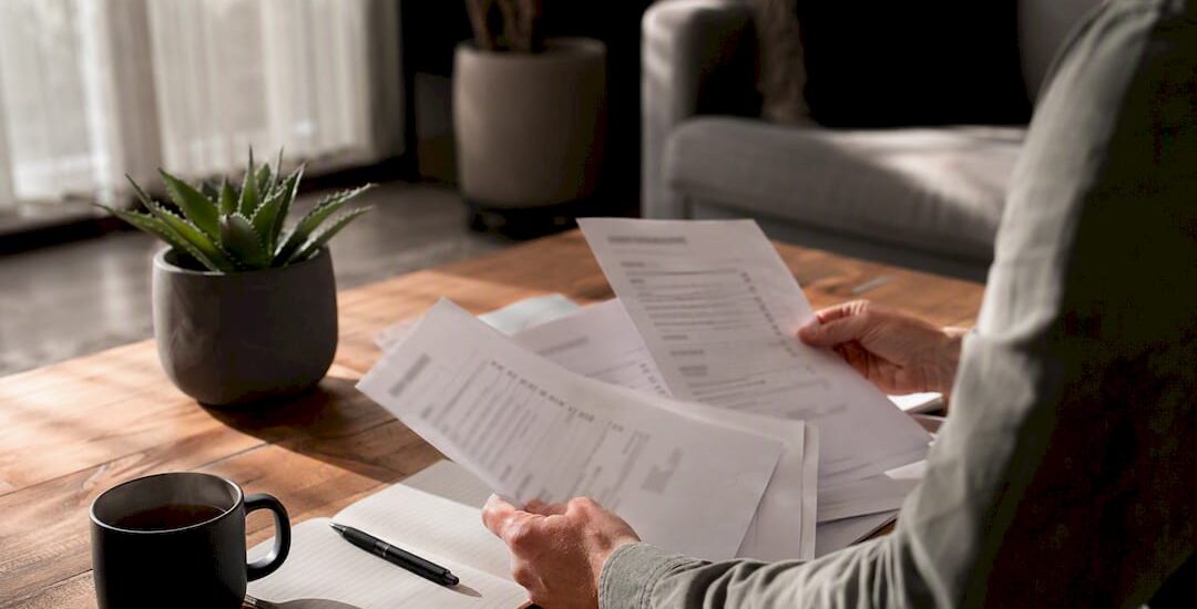 Hands comparing segmented moving quotes on desk