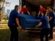 Removalist team loading furniture into truck