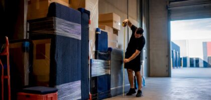 Removalist measuring household goods in warehouse