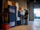 Removalist measuring household goods in warehouse