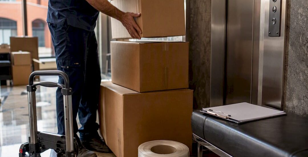 Mover arranging boxes by apartment service lift