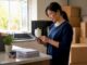 Woman coordinating moving concierge plans at home desk