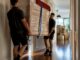 Movers carrying furniture through Australian home