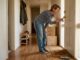 Woman checking front door lock on moving day