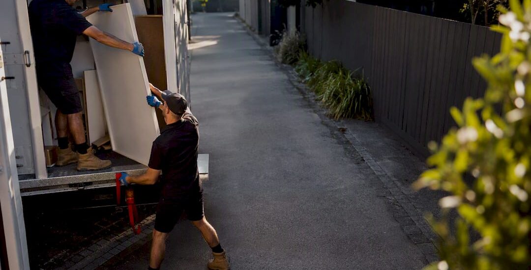 Removal crew loading bulky furniture waste