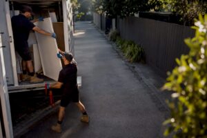 Removal crew loading bulky furniture waste