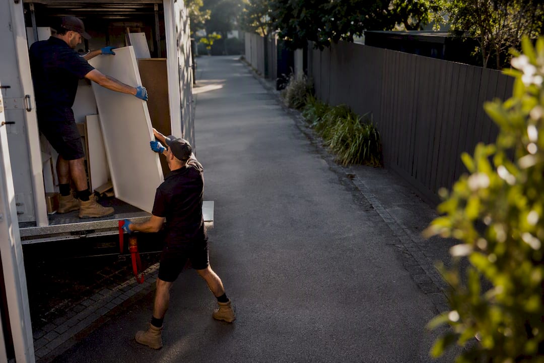 Removal crew loading bulky furniture waste