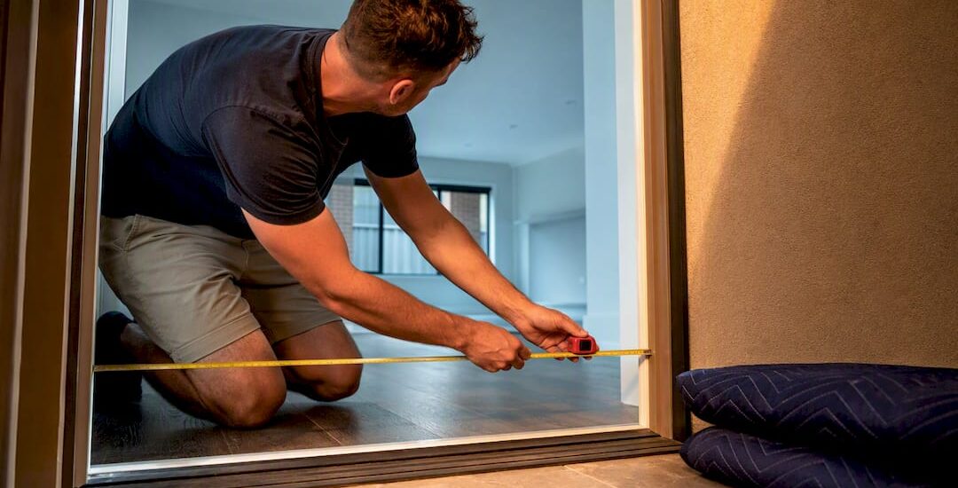 Homeowner measuring doorway for moving access