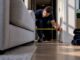 Removalist measuring furniture access at apartment doorway
