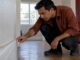 Property manager checking a rental skirting board