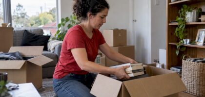 Homeowner packing books into a moving box