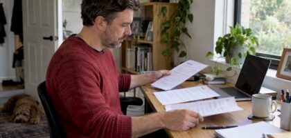 Homeowner comparing removalist quote sheets