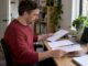 Homeowner comparing removalist quote sheets