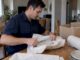 Mover wrapping a plate in packing paper